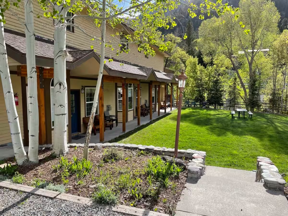 The Lumberyard building and lawn seen from the walkway, with aspens in new leaf