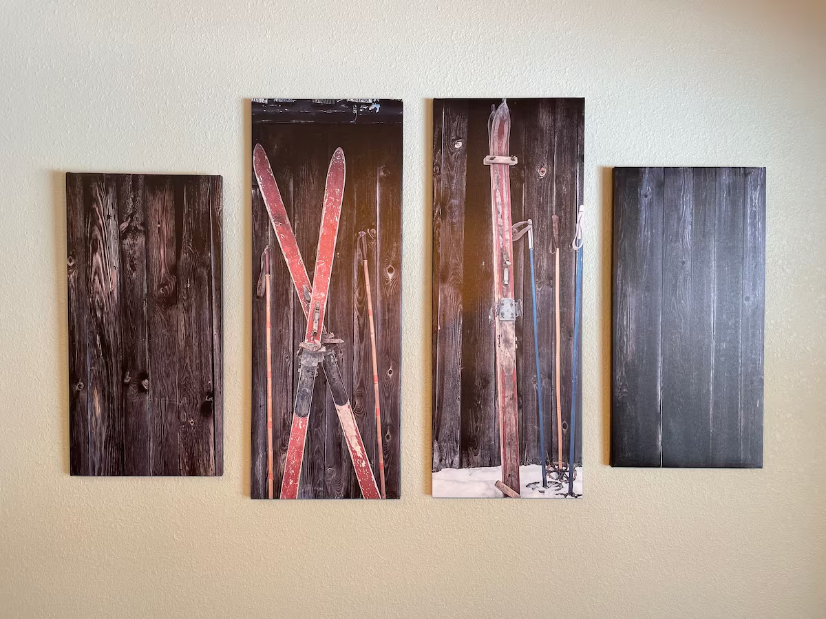 Four-panel canvas print of vintage red skis and poles against weathered barn wood
